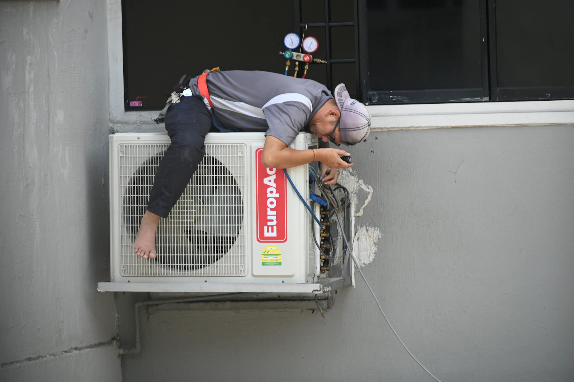 Outdoor HVAC condenser unit with technician